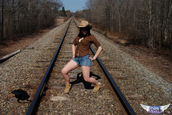 Young amateur Emily Love exposes herself on railway tracks in a hat and boots  - Outdoor, Beautiful, Amateur, Shorts, Spreading, Teen, Clothed, Cute, Babe, Solo  - Photo 1