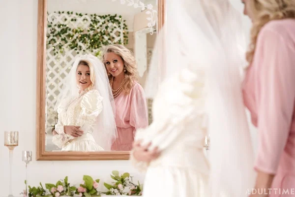 Carolina Sweets is affixed with a garter before a lesbian wedding to Julia Ann  - Wedding, Reality, Mature, Upskirt, Non Nude, MILF, Lesbian, Blonde, Skirt, Skinny  - Photo 15