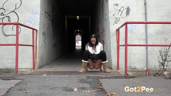 Brunette girl Eveline Neill gets caught pissing at a tunnel entrance in UGGs  - Public, Pissing, Pussy, Boots, Hairy, Spreading, Close Up, Brunette, Non Nude, Beautiful  - Photo 2