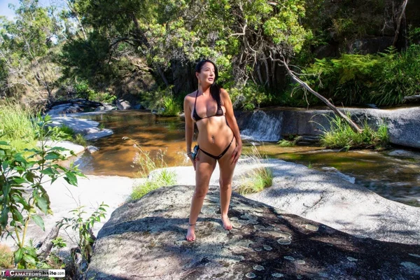 Brunette MILF Roxeanne undoes her bikini top while in a stream  - MILF, Bikini, Amateur, Outdoor, Wet, Brunette, Ass, PAWG, Legs  - Photo 1