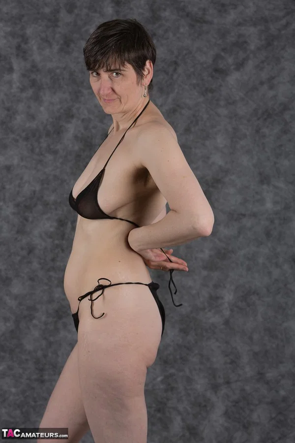 Short haired amateur holds her boobs after taking off a black bikini  - Saggy Tits, MILF, Short Hair, Bikini, Panties, Ass, Tiny Tits, Shaved, Legs, PAWG  - Photo 8