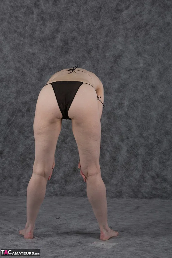 Short haired amateur holds her boobs after taking off a black bikini  - Saggy Tits, MILF, Short Hair, Bikini, Panties, Ass, Tiny Tits, Shaved, Legs, PAWG  - Photo 5