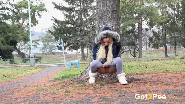 Blonde girl Victoria Pure pulls down her leggings to pee against a public tree  - Pissing, Public, Beautiful, Czech, Outdoor, Blonde, Close Up, Pussy, Shaved, Babe  - Photo 4