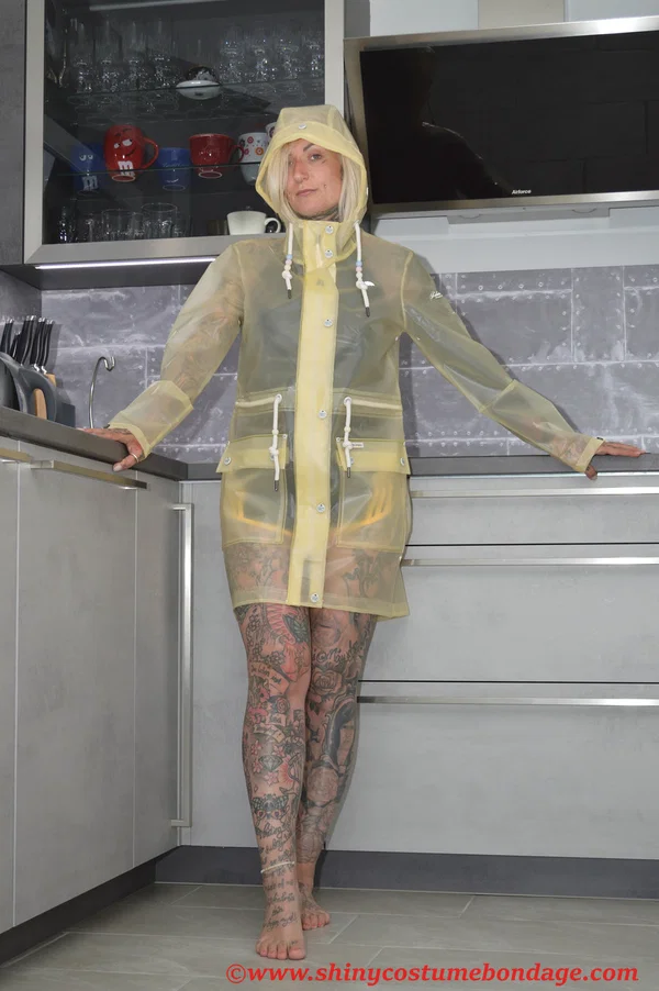 Tattooed blonde Miss Francine models barefoot in a raincoat over rubber wear  - Tattoo, Latex, Skirt, Fetish, Clothed, Kitchen, Shorts, Blonde, Non Nude  - Photo 2