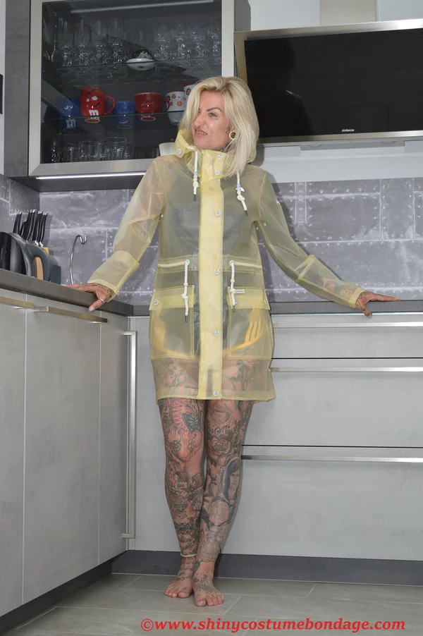Tattooed blonde Miss Francine models barefoot in a raincoat over rubber wear  - Tattoo, Latex, Skirt, Fetish, Clothed, Kitchen, Shorts, Blonde, Non Nude  - Photo 14