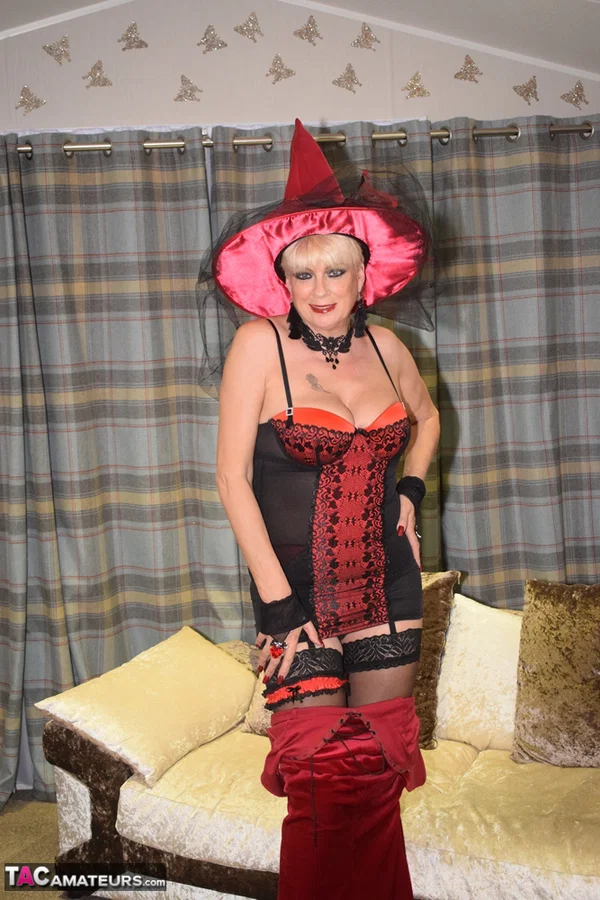 Older blonde removes a red velvet dress pose nude in a witch's hat and hosiery  - Cosplay, Mature, Amateur, Lingerie, Stockings, High Heels, Big Tits, Spreading, Clothed, Upskirt  - Photo 7