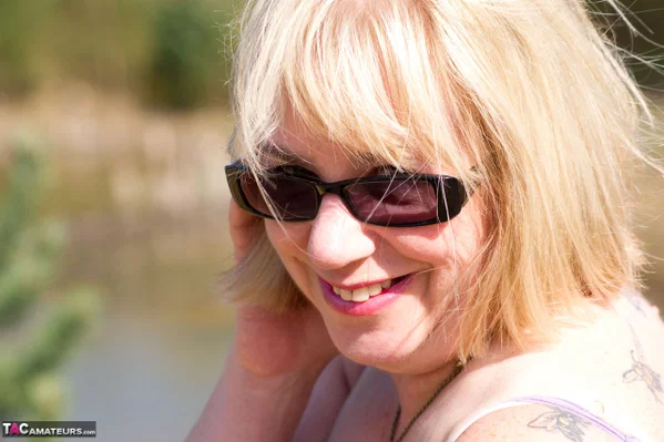 Blonde granny gets naked in sunglasses and stockings in a backyard  - Granny, Saggy Tits, Short Hair, Glasses, Chubby, Curvy, BBW, Stockings, Bikini, Thick  - Photo 2