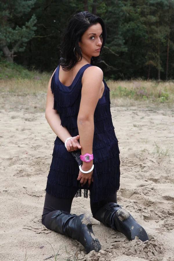 Brunette girl Nora is handcuffed to a tree while wearing a pink G-Shock watch  - Boots, Clothed, Beautiful, Outdoor, Leather, Skirt, Amateur, Solo, High Heels, Non Nude  - Photo 5