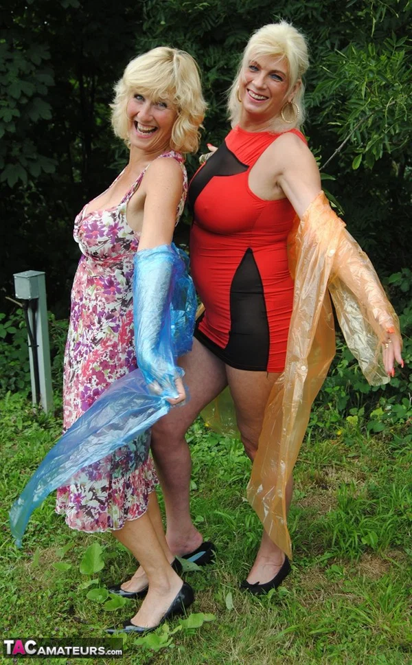 Mature lesbian Dimonty and GF cover their naked bodies in see thru raincoats  - Mature, Latex, Outdoor, Lesbian, Clothed, Skirt, Blonde, Humping, MILF, European  - Photo 11