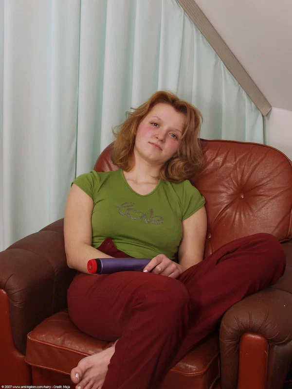 Natural redhead gets naked while masturbating with a vibrator on a chesterfield  - Amateur, Teen, Cute  - Photo 1