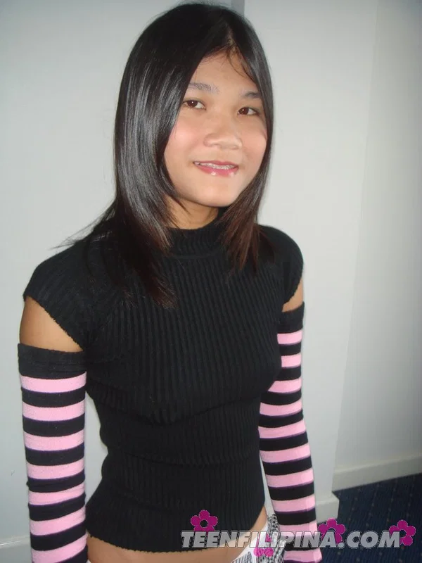 Young looking Filipina girl gets naked while wearing striped arm and leg socks  - Asian, Teen, Tiny Tits, Nipples, Hairy, Undressing, Pussy, Spreading, Skirt, Ass  - Photo 1