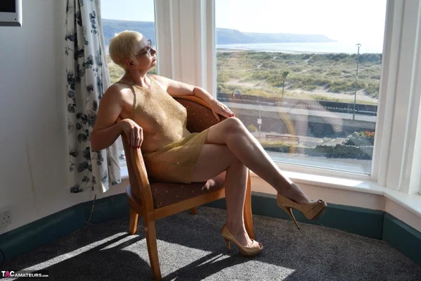 Big titted older woman Barby Slut showcases her bald twat in front of a window  - Mature, Glasses, BBW, Skirt, Thick, Chubby, Curvy, Short Hair, Legs, Spreading  - Photo 1