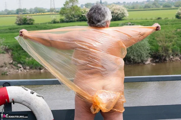 Obese oma Grandma Libby doffs a see-through raincoat to get naked on a bridge  - SSBBW, Granny, Saggy Tits, BBW, Chubby, Amateur, Curvy, Fetish, Thick, Glasses  - Photo 17
