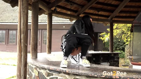Dark haired girl pisses on the counter of an outdoor bar in an act of revenge  - Pissing, Outdoor, Spreading, Babe, Shaved, Close Up, Pussy, Clothed, Beautiful, Solo  - Photo 3