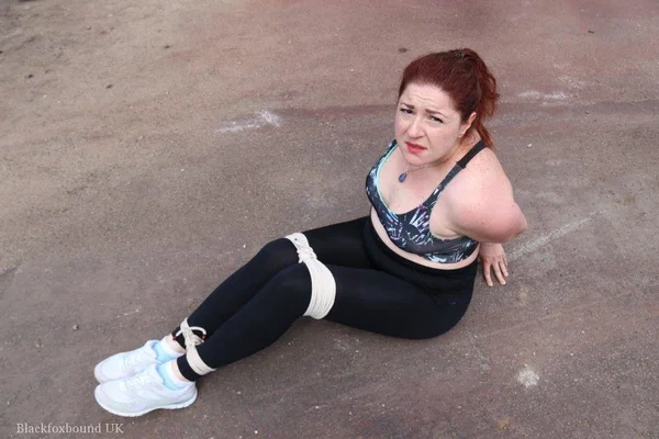 Redheaded girl Mada Rose is left on a paved lot while tied up  - Yoga Pants, Redhead, MILF, BDSM, Outdoor, Clothed, Bondage, Pigtails  - Photo 3