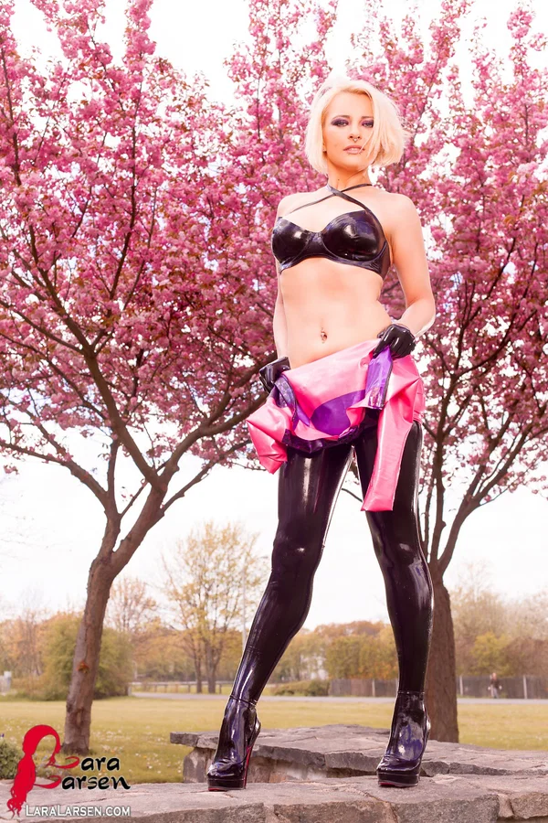 Blonde Lara Larsen unzips a latex dress to expose a matching bra in a park  - Latex, Fetish, Amateur, Clothed, Outdoor, Babe, Lingerie, Redhead, High Heels, Ass  - Photo 11