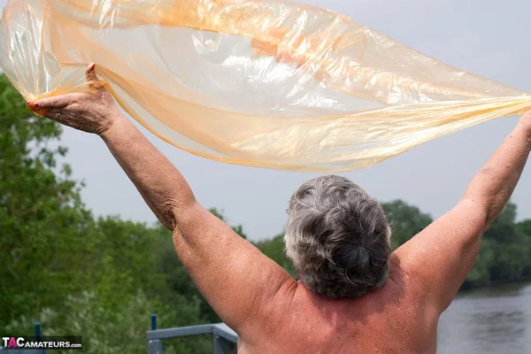 Obese oma Grandma Libby doffs a see-through raincoat to get naked on a bridge  - SSBBW, Granny, Saggy Tits, BBW, Chubby, Amateur, Curvy, Fetish, Thick, Glasses  - Photo 18