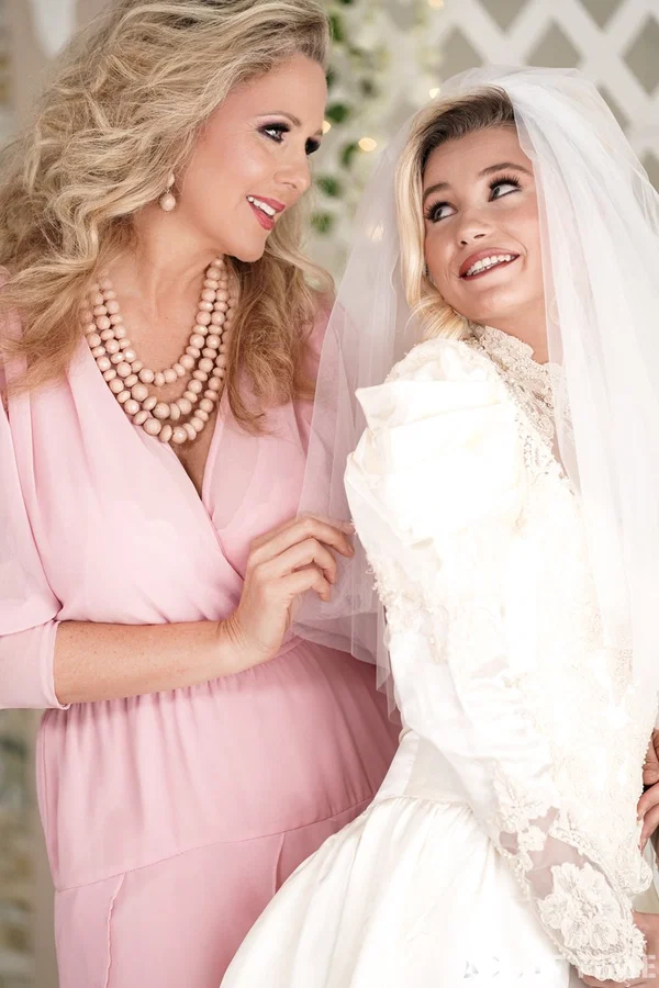 Carolina Sweets is affixed with a garter before a lesbian wedding to Julia Ann  - Wedding, Reality, Mature, Upskirt, Non Nude, MILF, Lesbian, Blonde, Skirt, Skinny  - Photo 6