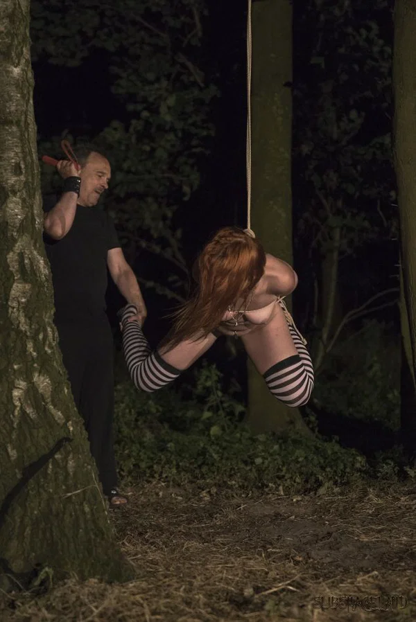 Restrained redhead is flogged and masturbated in the woods at night  - Spanking, BDSM, Bondage, Redhead, Stockings, Outdoor, Panties, Natural Tits, Spreading, Tiny Tits  - Photo 11