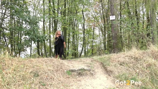Blonde girl Jenna Lovely takes a piss while descending a bank near the woods  - Pissing, MILF, Outdoor, Spreading, Pussy, Panties, Close Up, Shaved, Clothed, Skirt  - Photo 1
