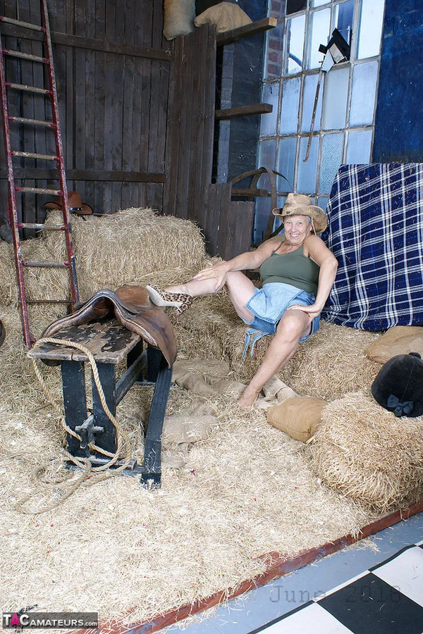 Old woman Savana rides a saddle in the feed room before baring her large boobs  - Granny, Farm, Amateur, Clothed, Big Tits, Lingerie, Spreading  - Photo 10