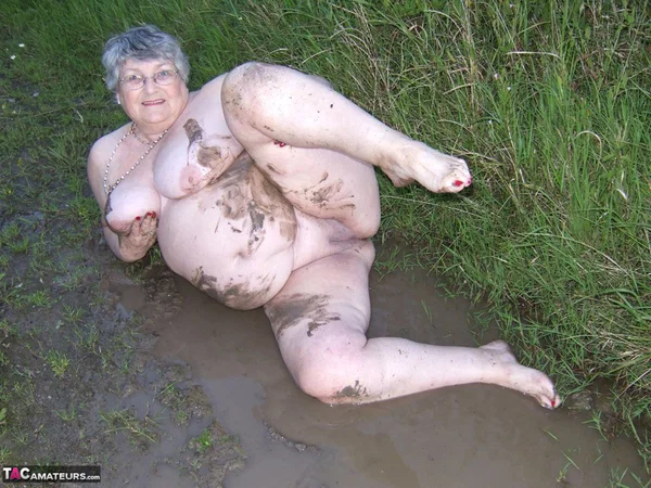 Fat nan Grandma Libby steps into a puddle before covering herself in mud  - Granny, BBW, Saggy Tits, Outdoor, Amateur, Chubby, Wet, Glasses, Curvy, Thick  - Photo 13