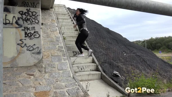 Dark haired girl Dee pulls down her leggings for a pee on concrete stairs  - Public, Pissing, Pussy, Glasses, Latina, Shaved, Leather, MILF, Spreading, Brunette  - Photo 1