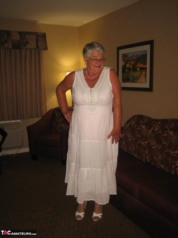 Old amateur Girdle Goddess lets her boobs loose while on a chesterfield  - Granny, BBW, Glasses, Stockings, Chubby, Amateur, Short Hair, High Heels, Curvy, Skirt  - Photo 1