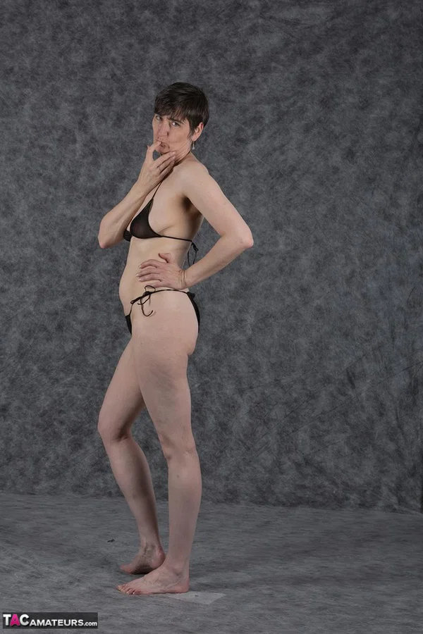 Short haired amateur holds her boobs after taking off a black bikini  - Saggy Tits, MILF, Short Hair, Bikini, Panties, Ass, Tiny Tits, Shaved, Legs, PAWG  - Photo 7