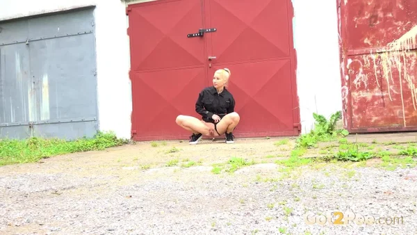 Blonde girl Nykla hitches up her dress before taking a piss by a garage  - Pissing, Pussy, Close Up, Panties, Shaved, Spreading, Outdoor, Skirt, Beautiful, Solo  - Photo 5